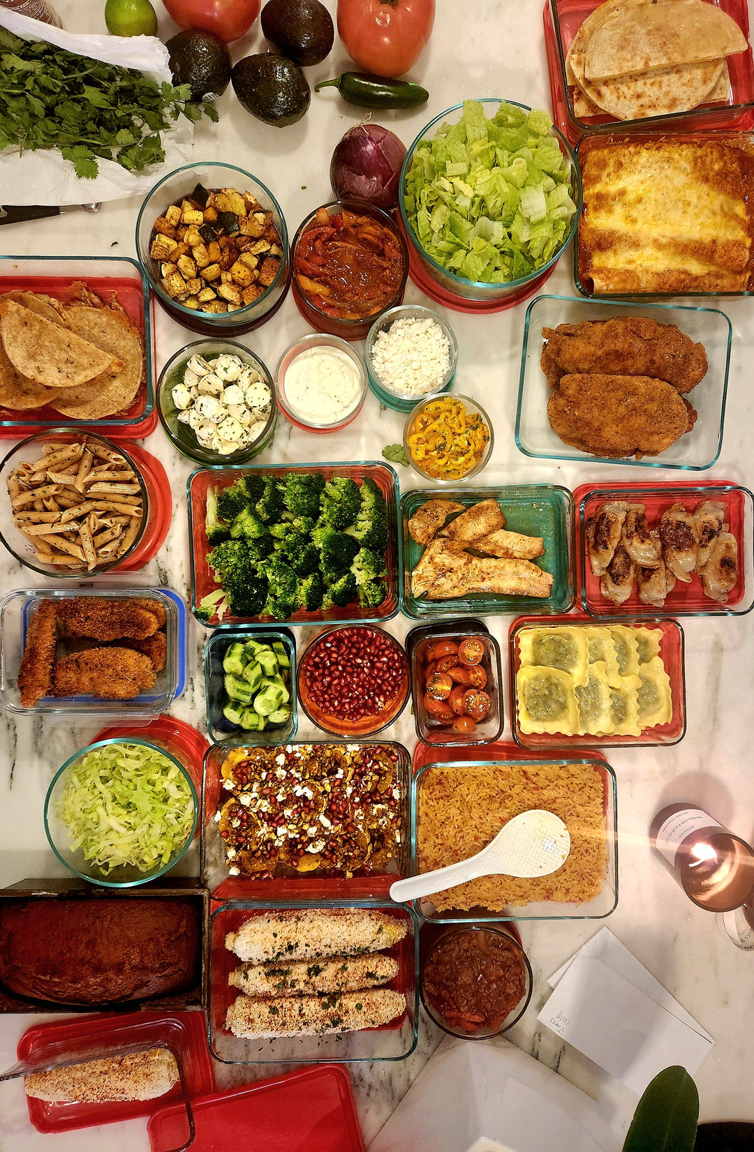 Assorted food items including vegetables, meats, and sauces on a table.