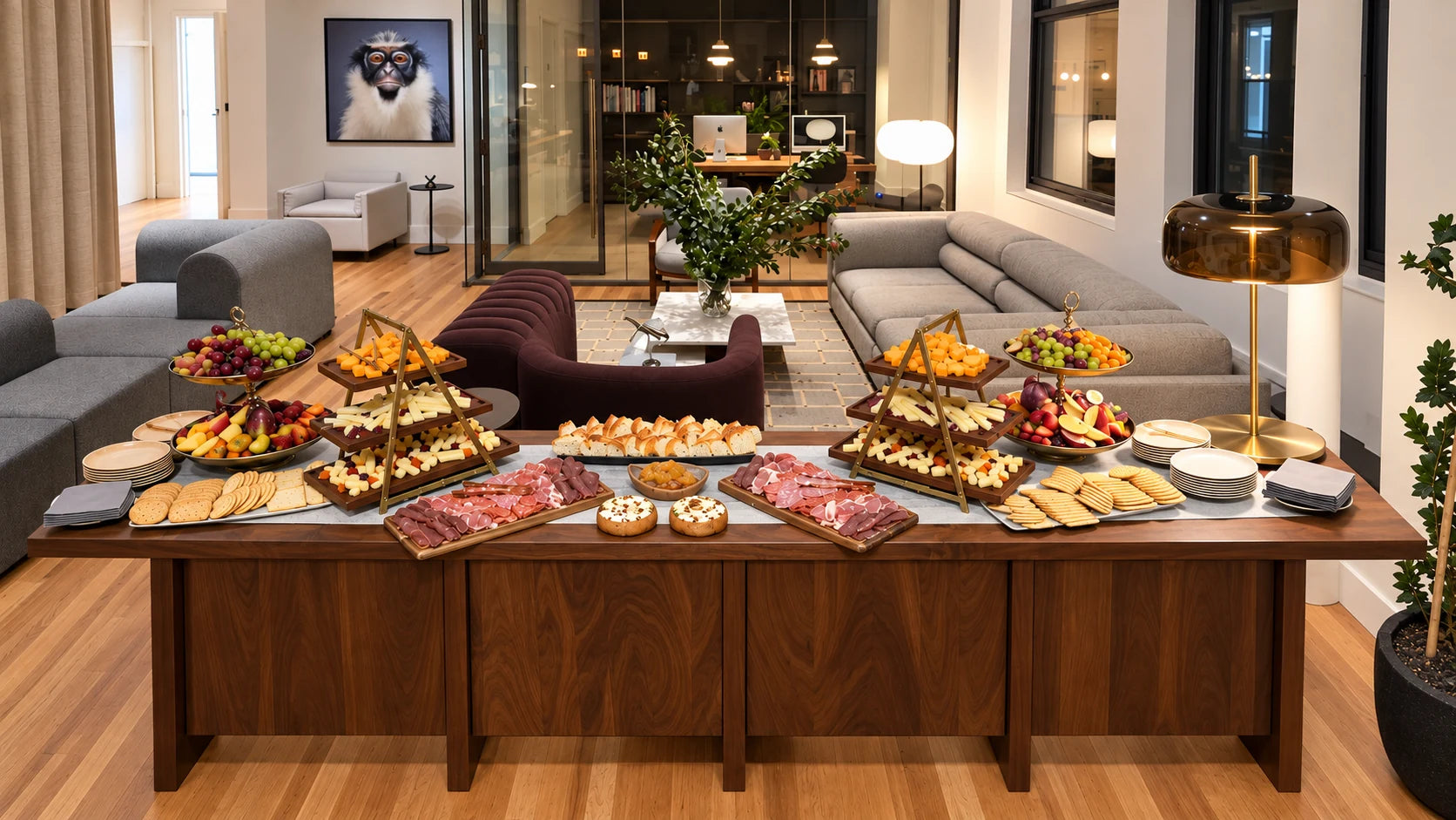 A food spread arranged across a wooden table in a light living room.