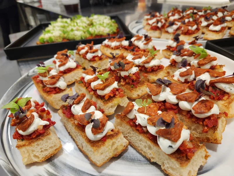 Trays of crostini topped and arranged for service.