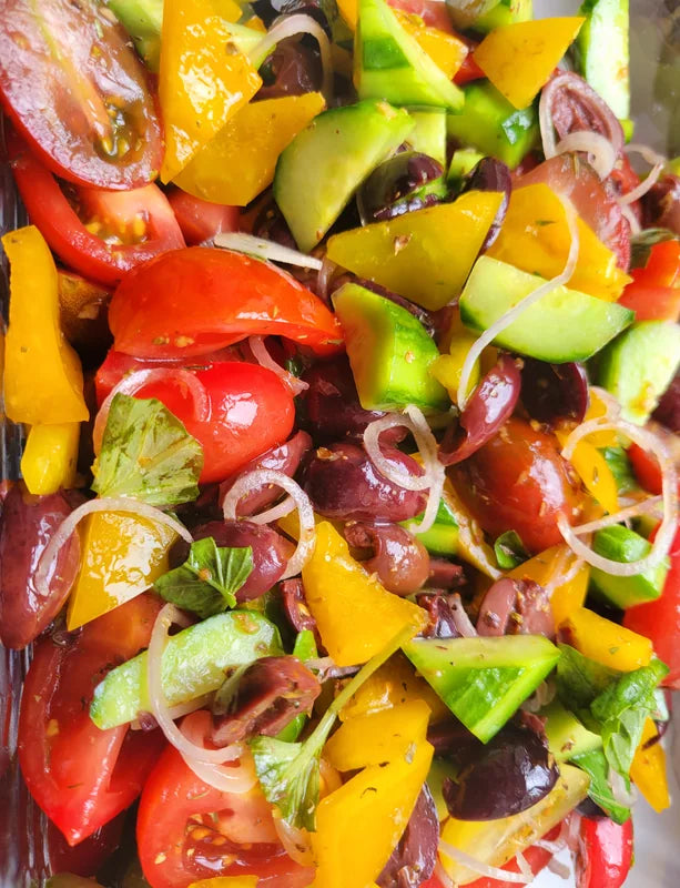 A close view of a colourful salad in a serving dish.